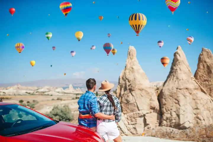 Couple viewing fairy chimneys and hot air balloons