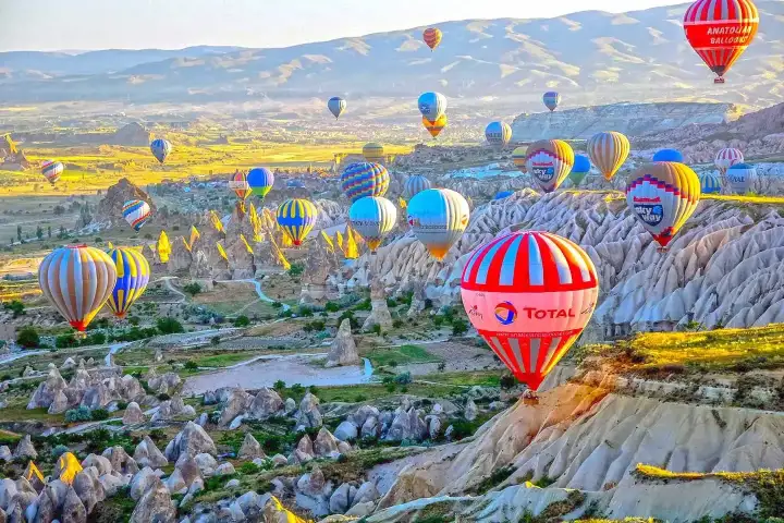 Bright sunrise with colorful balloons in Cappadocia