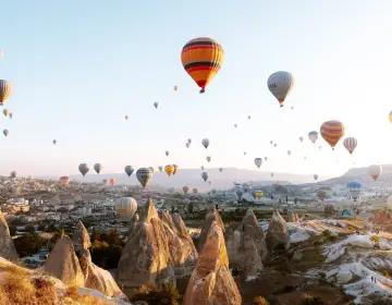 Colorful balloons floating on Cappadocia horizon