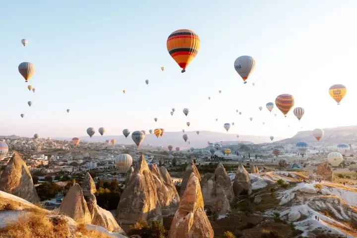 Colorful balloons floating on Cappadocia horizon