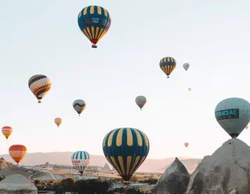 Colorful fleet of Cappadocia balloons launching
