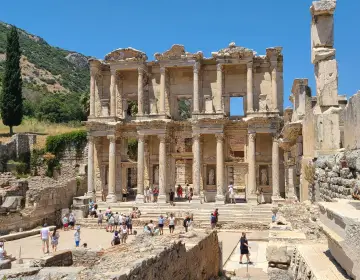 Tourists visiting historic landmark Celsus Library Ephesus