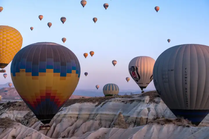 Sunrise view of balloons over Cappadocia ridge