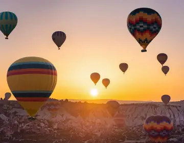 Sunset balloons floating over fairy chimneys