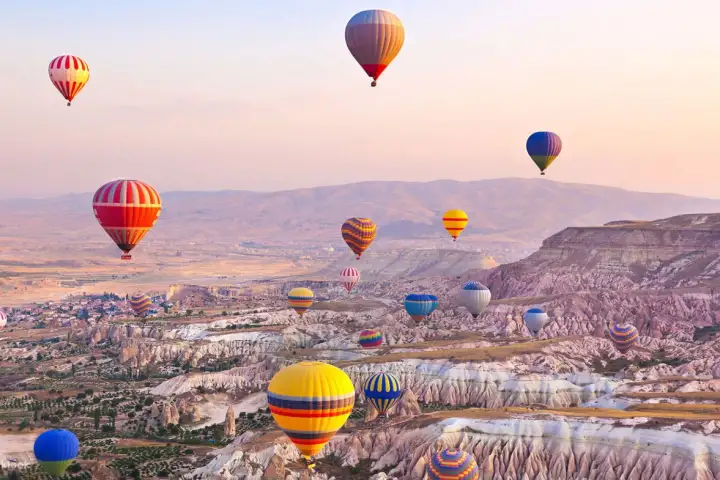 Twilight sky filled with hot air balloons in Cappadocia