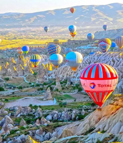 Bright sunrise with colorful balloons in Cappadocia