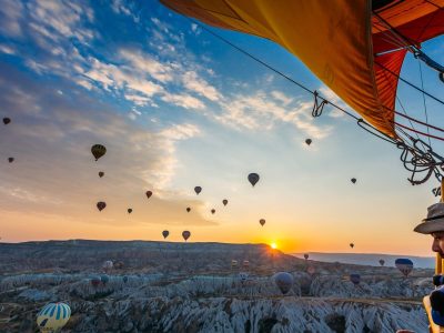 Hot air balloon over canyon ridge in Cappadocia