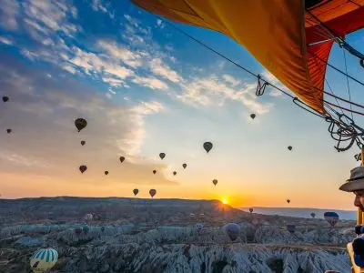 Hot air balloon over canyon ridge in Cappadocia