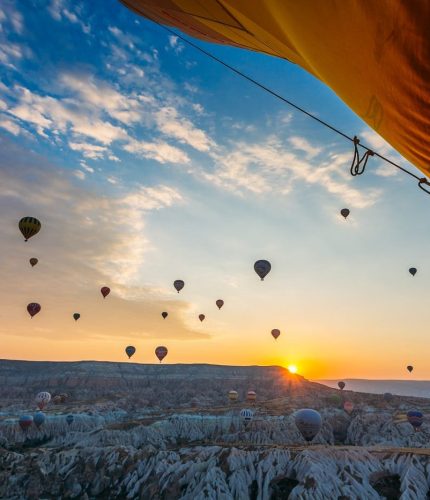 Hot air balloon over canyon ridge in Cappadocia