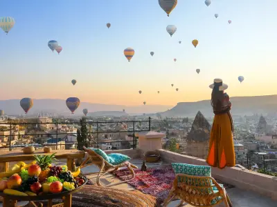 Terrace breakfast table at sunrise with hot air balloons