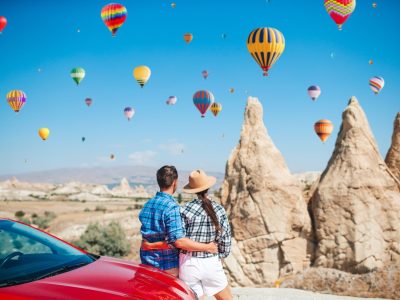 Couple viewing fairy chimneys and hot air balloons