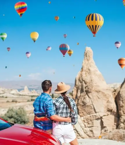 Couple viewing fairy chimneys and hot air balloons