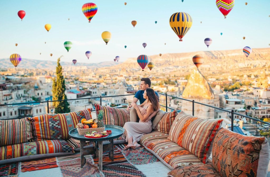 Rooftop coffee breakfast setting with hot air balloons