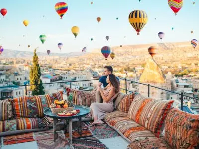 Rooftop coffee breakfast setting with hot air balloons
