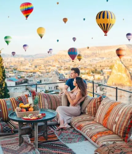 Rooftop coffee breakfast setting with hot air balloons