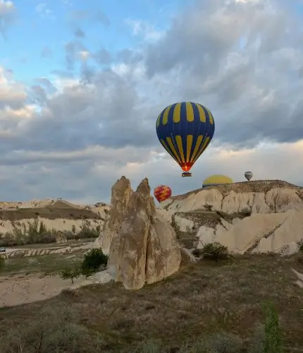 Sunrise balloon flight over Cappadocia rocks