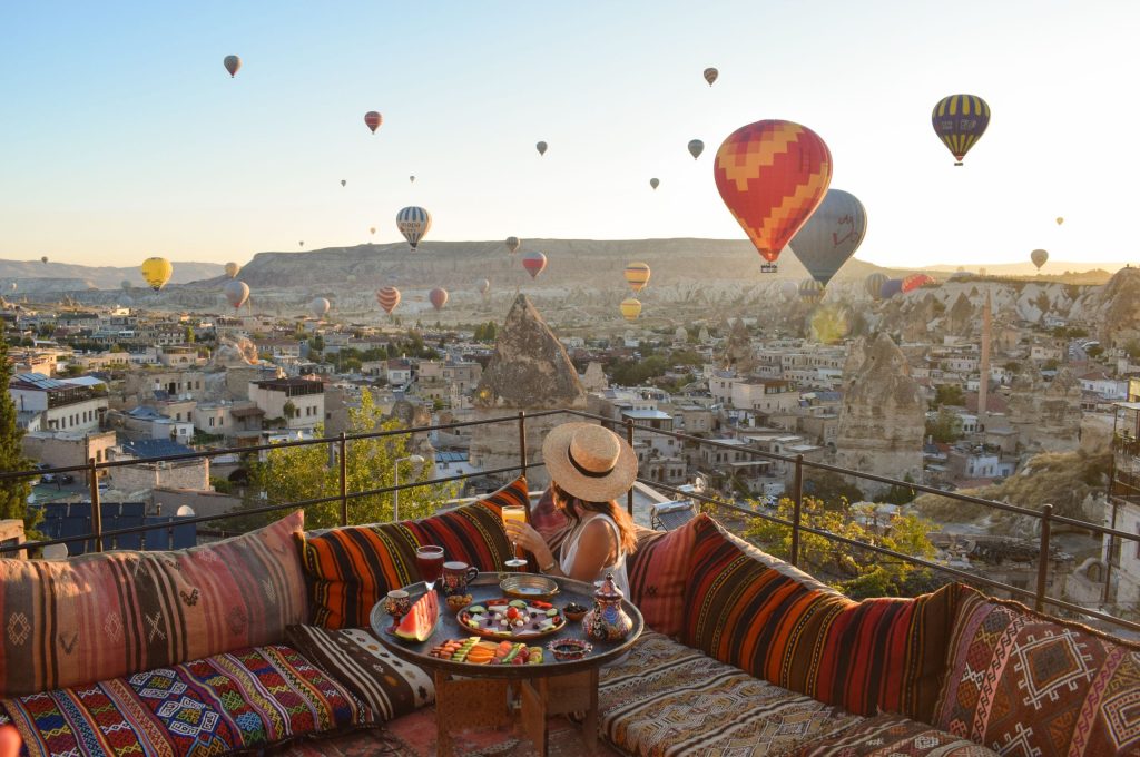 Traditional terrace breakfast at sunrise with balloons