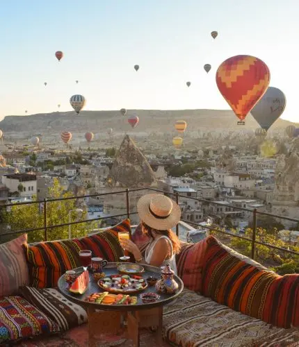 Traditional terrace breakfast at sunrise with balloons
