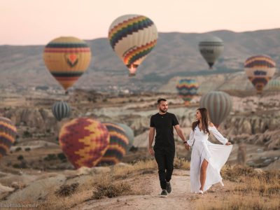 Wedding couple posing in Cappadocia landscape with balloons