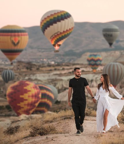 Wedding couple posing in Cappadocia landscape with balloons