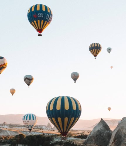 Colorful fleet of Cappadocia balloons launching
