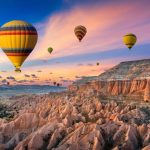 Hillside view of hot air balloons in Cappadocia