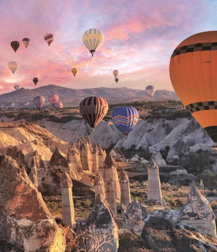 Purple sunset landscape with Cappadocia balloons