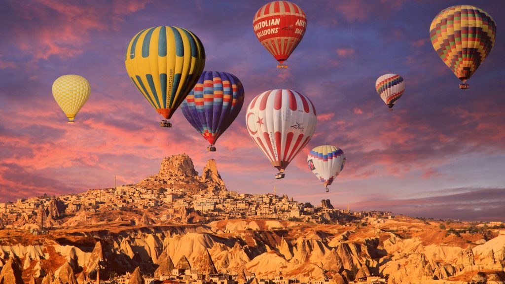 Warm tones of sunset balloons in Cappadocia