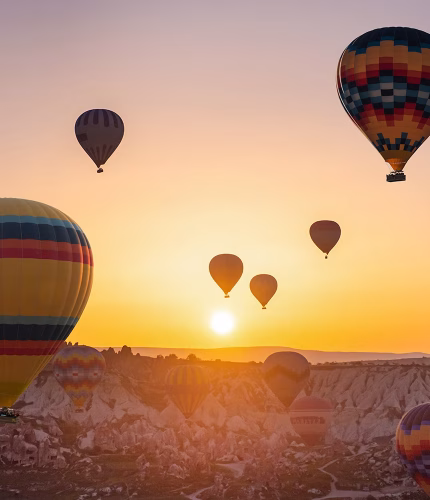 Sunset balloons floating over fairy chimneys
