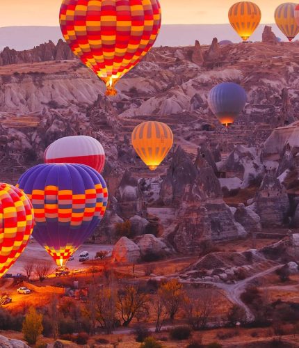 Sunset valley view with Cappadocia hot air balloons