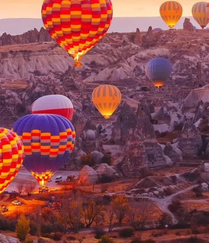 Sunset valley view with Cappadocia hot air balloons