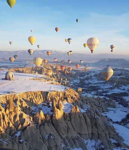 Valleys and balloons in winter Cappadocia scenery