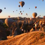 Warm evening light with balloons over Cappadocia