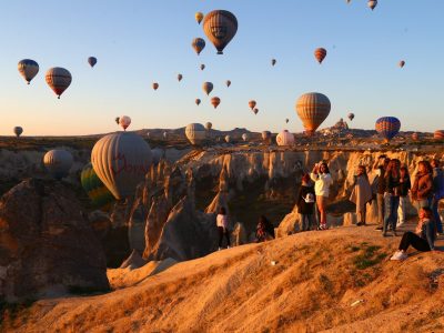 Warm evening light with balloons over Cappadocia