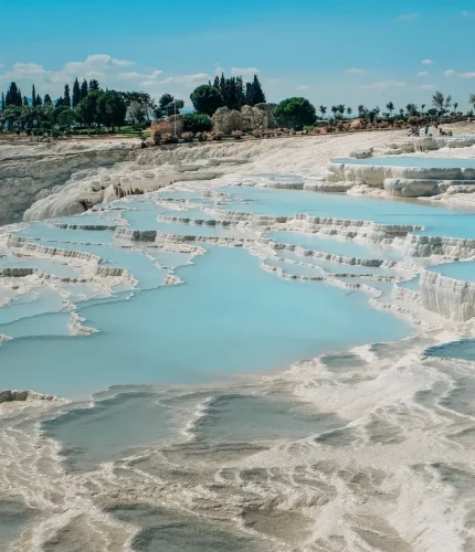 Pamukkale white cliffs with thermal water steam in morning light